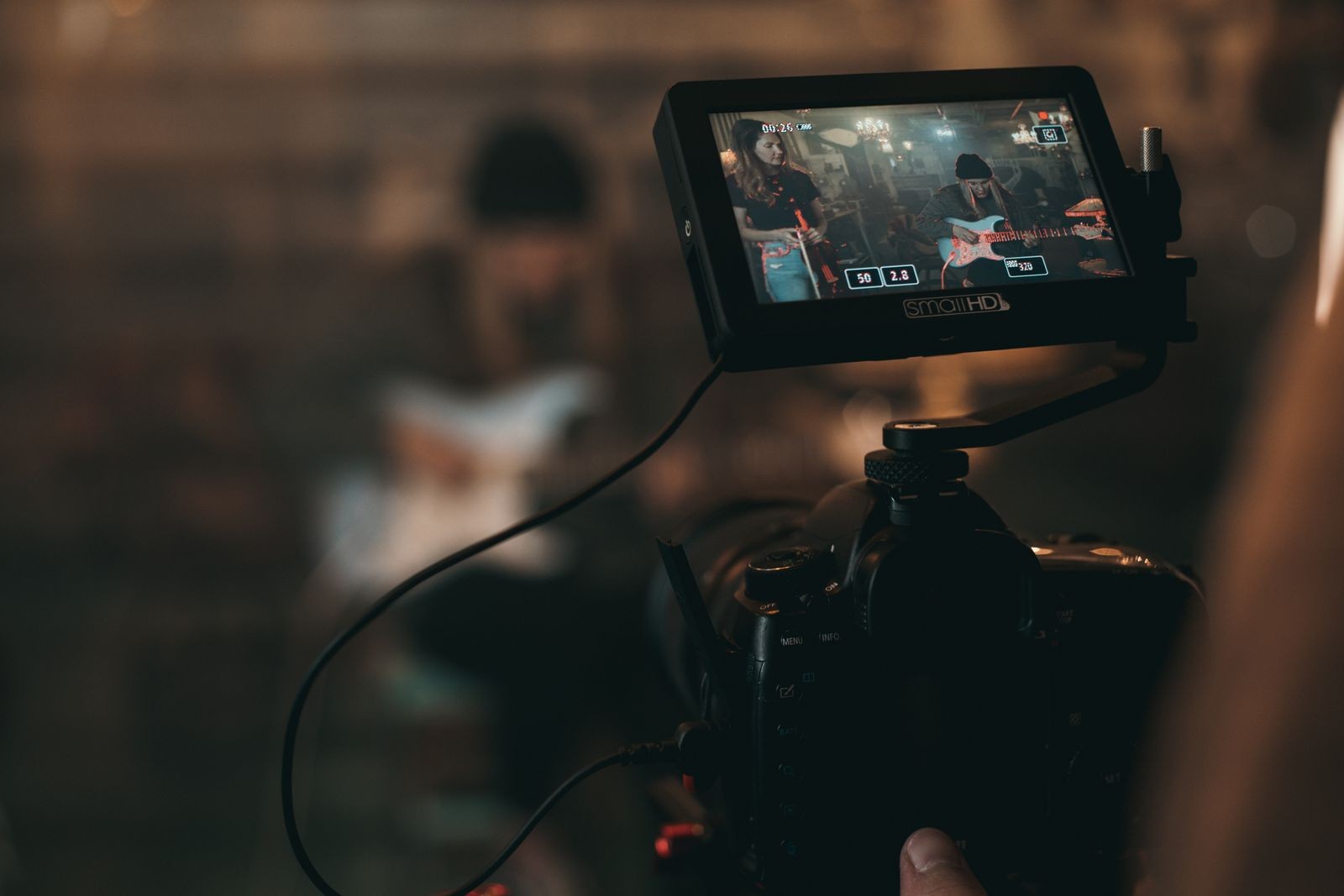 On-set camera monitor showing a live music video shoot